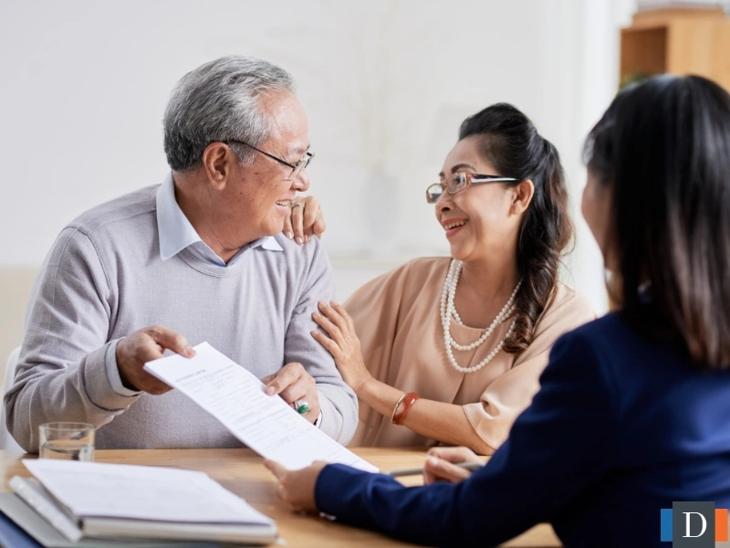 A couple looking at a legal document with a lawyer. This image is for the blog titled "What is Estate Administration?"