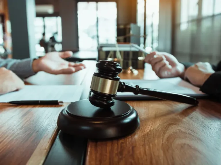 image of a judge's gavel on the desk of lawyers in discussion, used for the blog "what is civil litigation?" for Cary and Wake Forest attorneys at Doyle Law