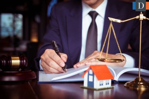 An estate planning attorney is shown writing a will.