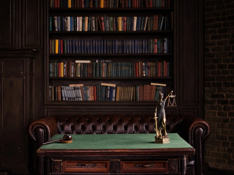 Lawyer's office with legal books and a gavel. This image accompanies the page titled Cary Wills and Estates Attorney.