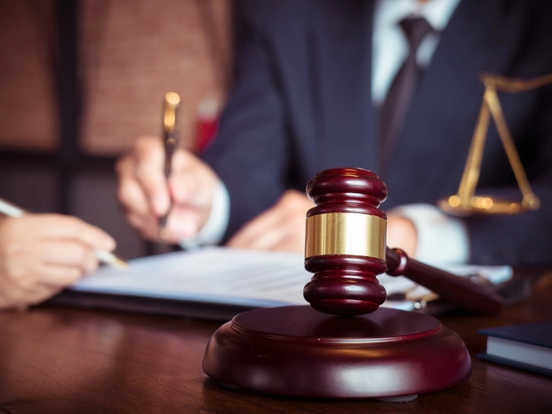 An estate administration attorney administers a document for a client in an office.