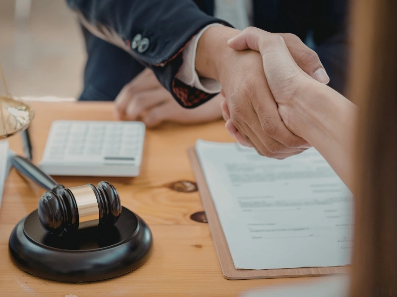 A Cary estate planning attorney shakes hands with a client.