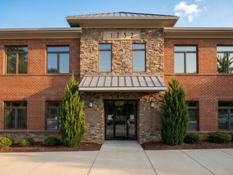 Brick office building in daylight. The Doyle Law Offices - Wake Forest, NC Office Entrance. Wake Forest lawyer for wills, estates, estate planning, probate and inheritance disputes.