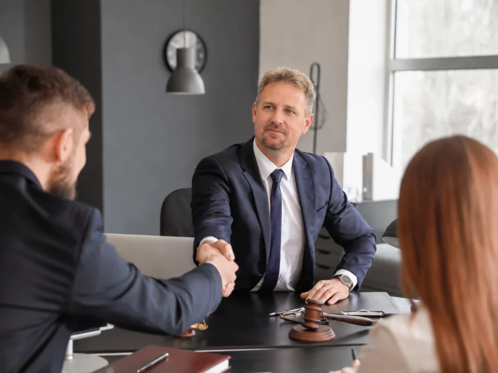 an attorney in Cary, NC answer, "what is a power of attorney" to clients in a modern office.